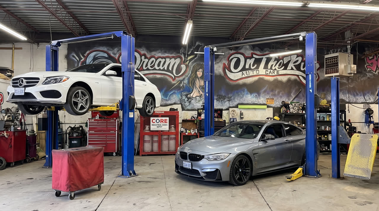 Two cars up on the lifts in the main bay